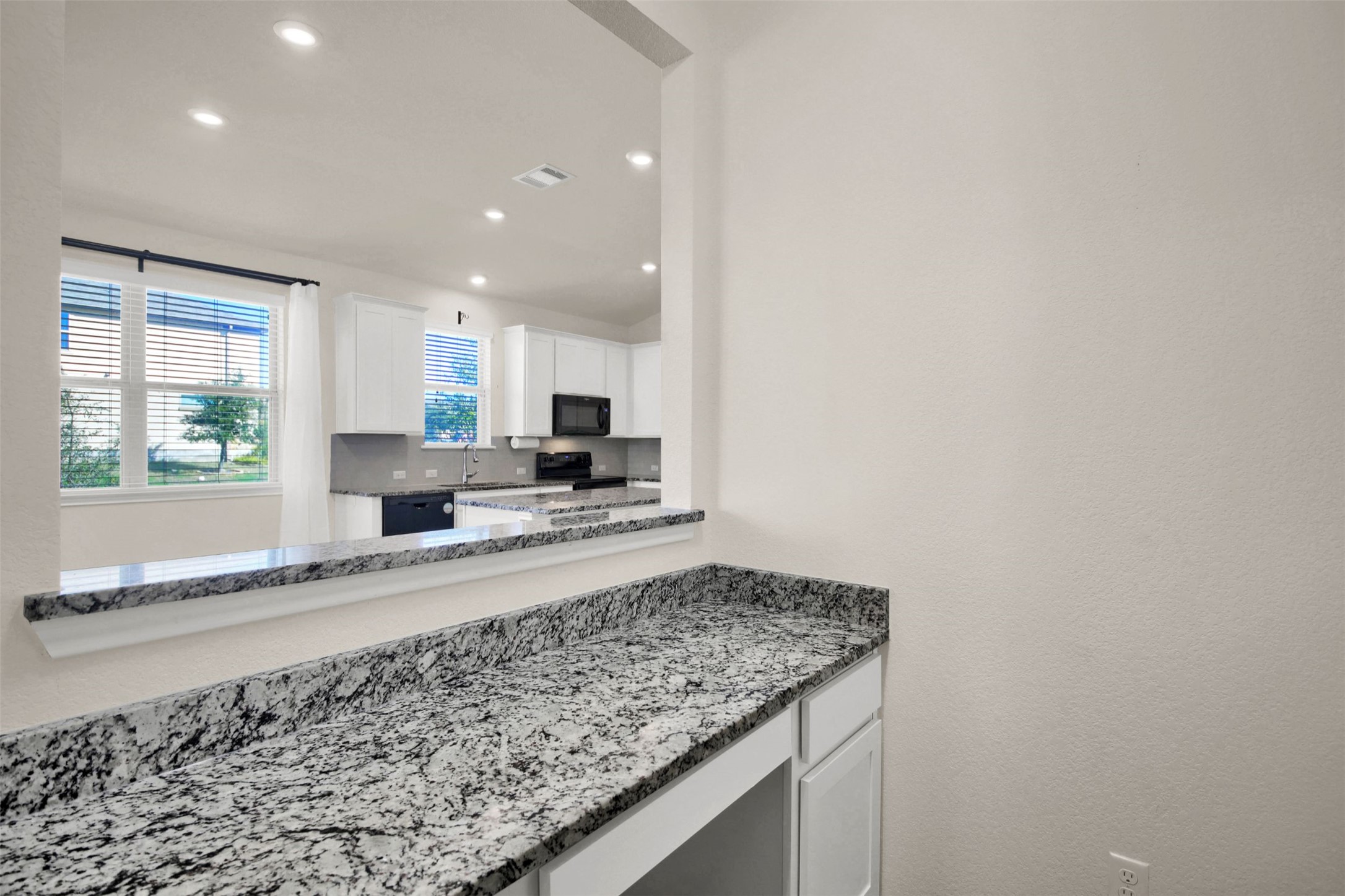 19032 Quebrada Drive Pflugerville, TX 78660 - Photo 19 of 29 a kitchen with granite countertop sink and stove top oven