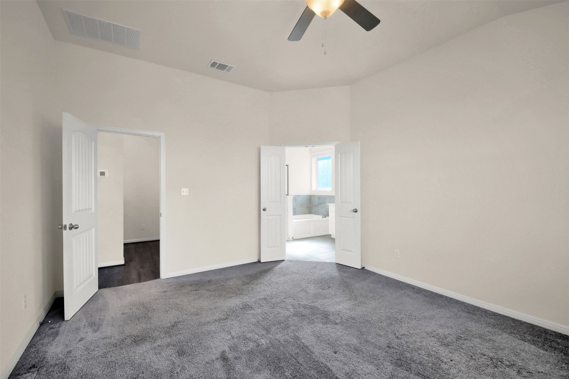 19032 Quebrada Drive Pflugerville, TX 78660 - Photo 21 of 29 an empty room with chandelier fan and windows