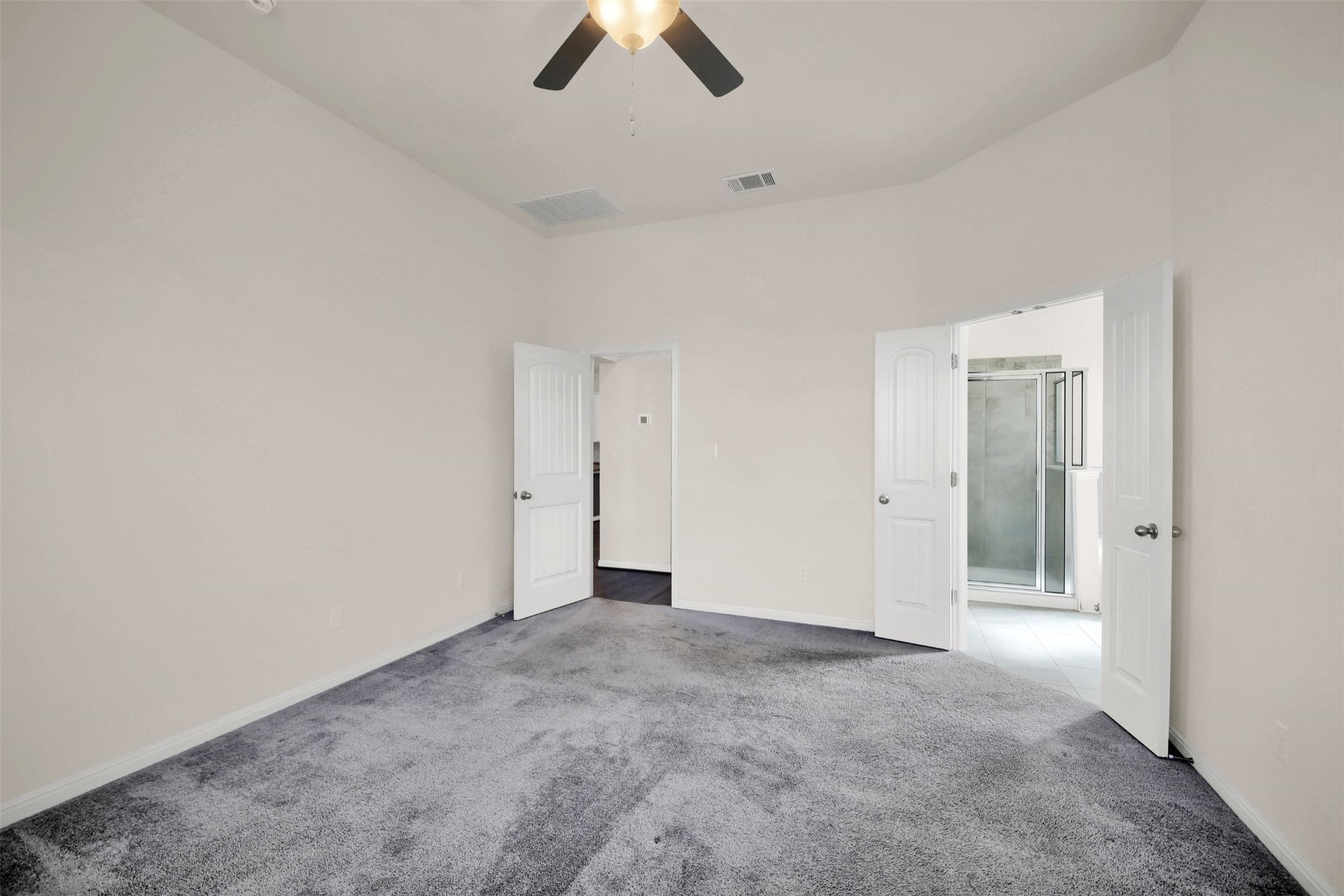 19032 Quebrada Drive Pflugerville, TX 78660 - Photo 22 of 29 an empty room with chandelier fan and windows