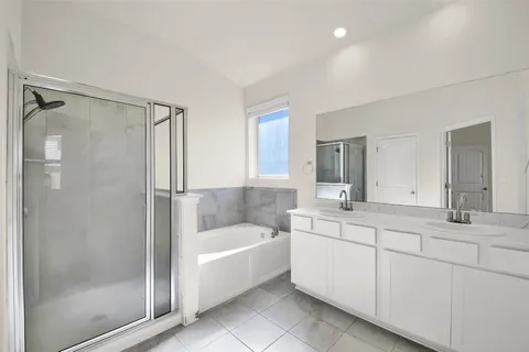 a bathroom with a tub sink and mirror