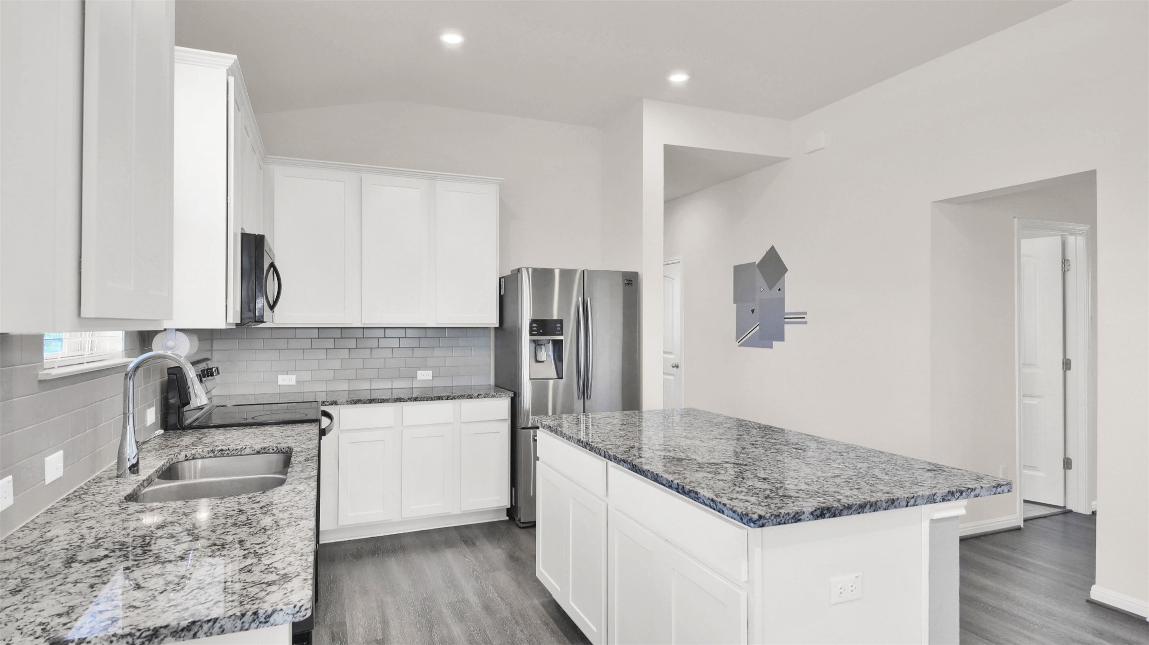 19032 Quebrada Drive Pflugerville, TX 78660 - Photo 7 of 29 a kitchen with stainless steel appliances granite countertop a sink stove and refrigerator