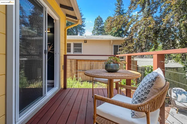 a view of balcony with table and chairs
