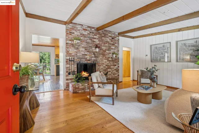 a living room with furniture a fireplace and a table