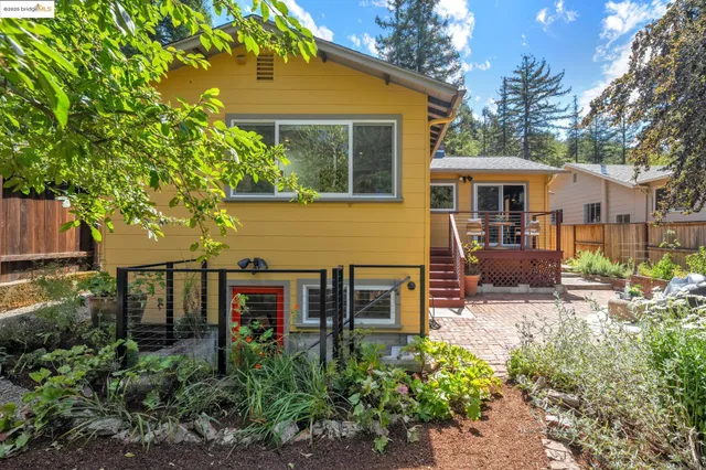 a view of a house with backyard sitting area and garden