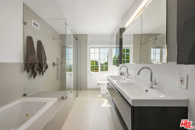a bathroom with a tub sink and mirror