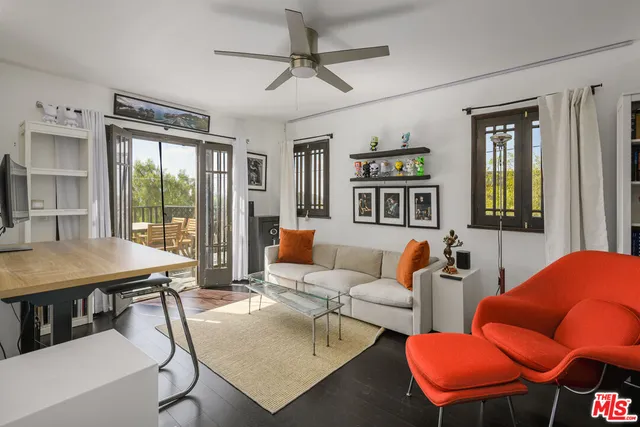 a living room with furniture a table and chairs