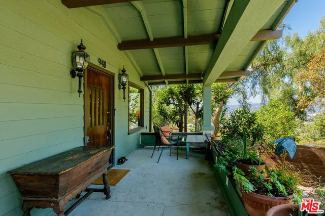 a backyard of a house with outdoor seating