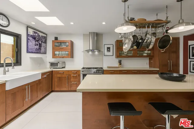 a kitchen with a sink a stove and a wooden cabinets