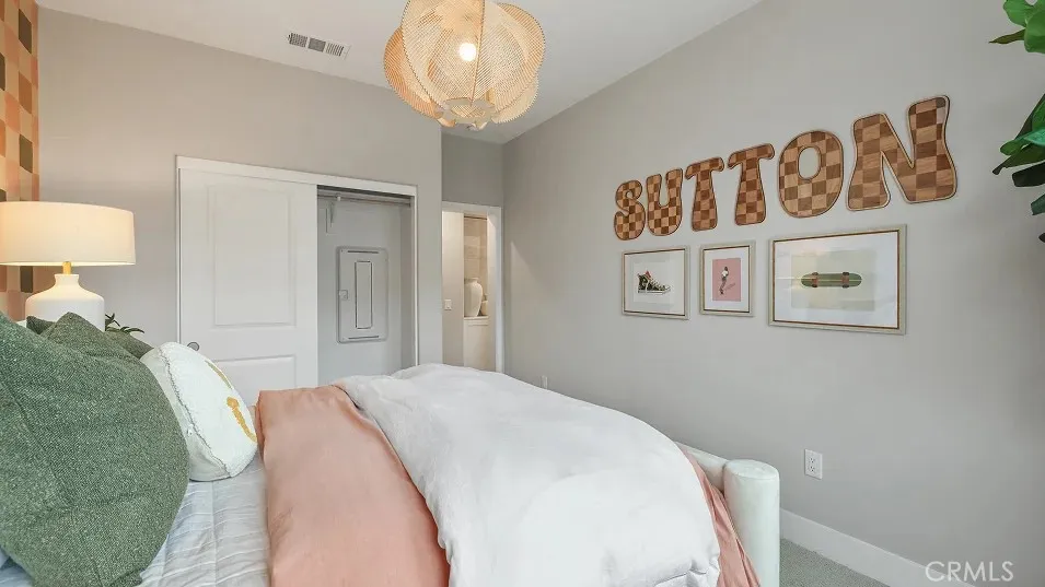 1723 Lychee Street Fullerton, CA 92835 - Photo 12 of 25 a bedroom with a bed and a chandelier