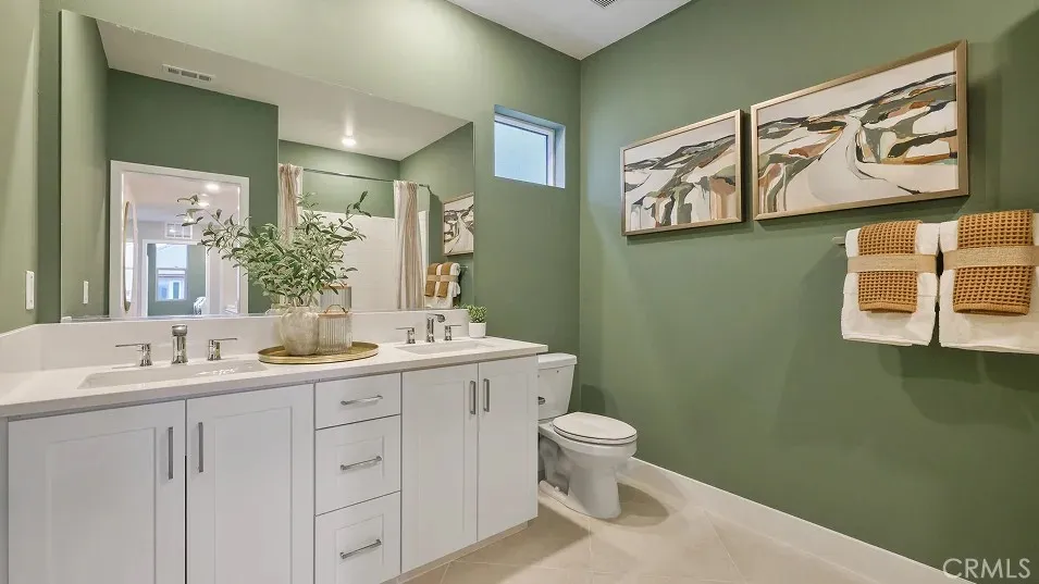 1723 Lychee Street Fullerton, CA 92835 - Photo 13 of 25 a bathroom with a toilet sink and mirror