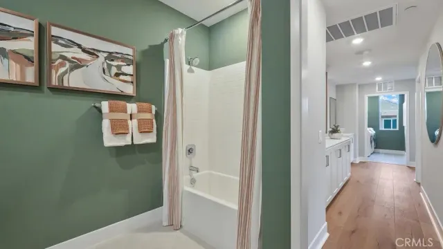 a view of a hallway with wooden floor and windows