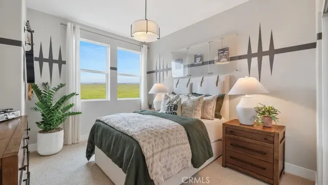 a bedroom with a bed and a potted plant