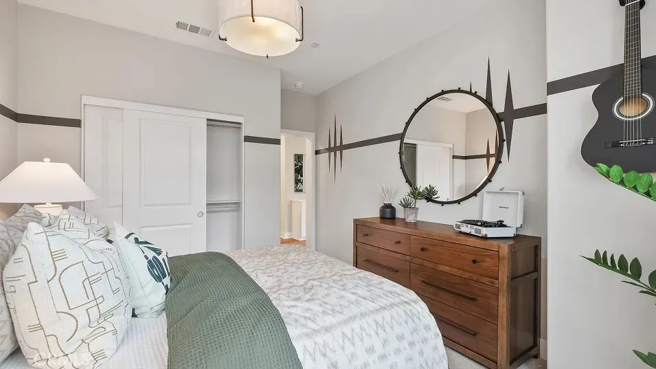 1723 Lychee Street Fullerton, CA 92835 - Photo 16 of 25 a bed room with a bed a mirror and a chandelier