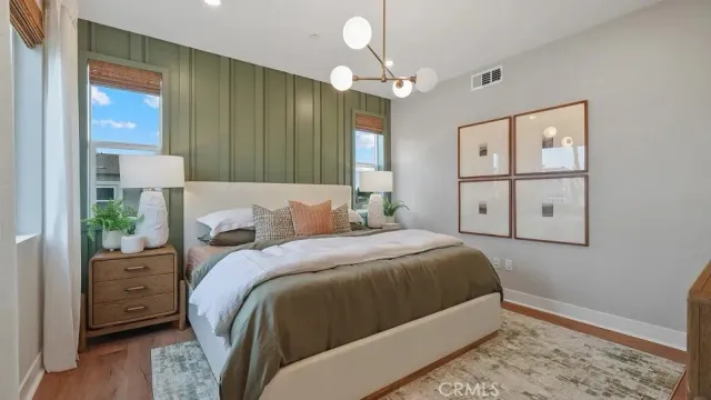a bedroom with a bed and a chandelier