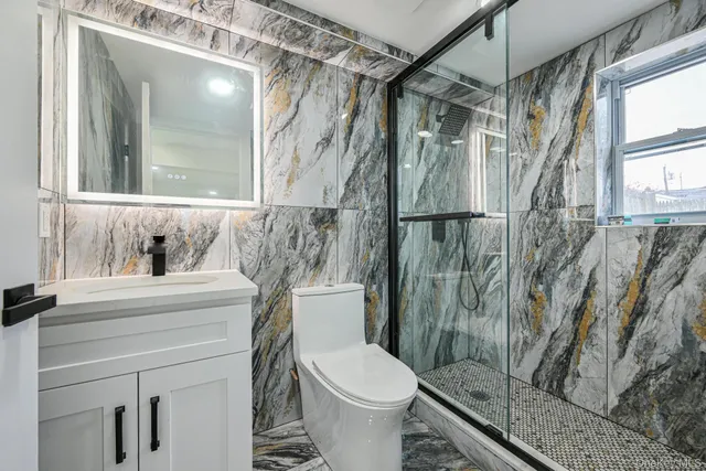 a bathroom with a toilet and a shower