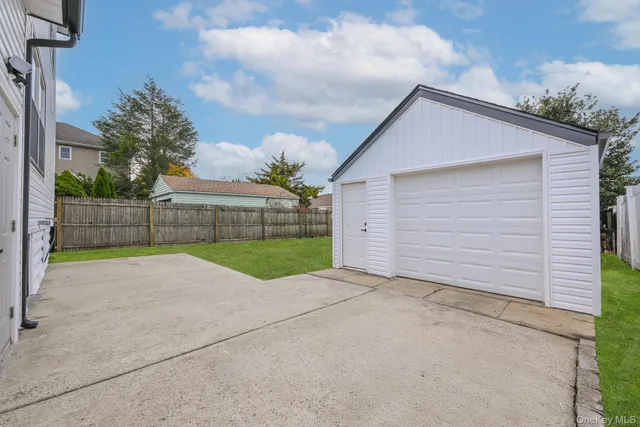 a view of a backyard with brick wall and fence