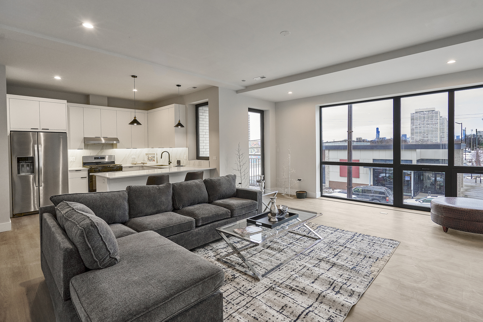 451 East Pershing Road, Unit 303 Chicago, IL 60653 - Photo 13 of 30 a living room with furniture and a large window