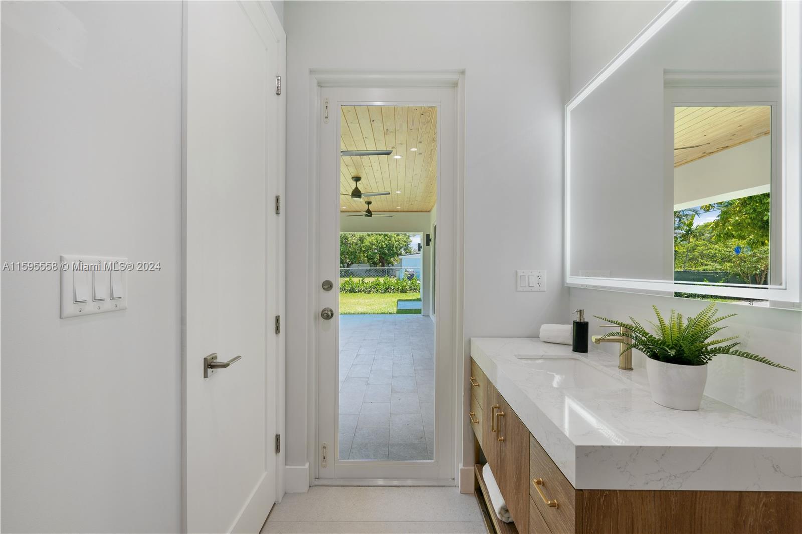 11815 Southwest 82nd Road Miami, FL 33156 - Photo 30 of 47 a bathroom with a sink a potted plant and a window