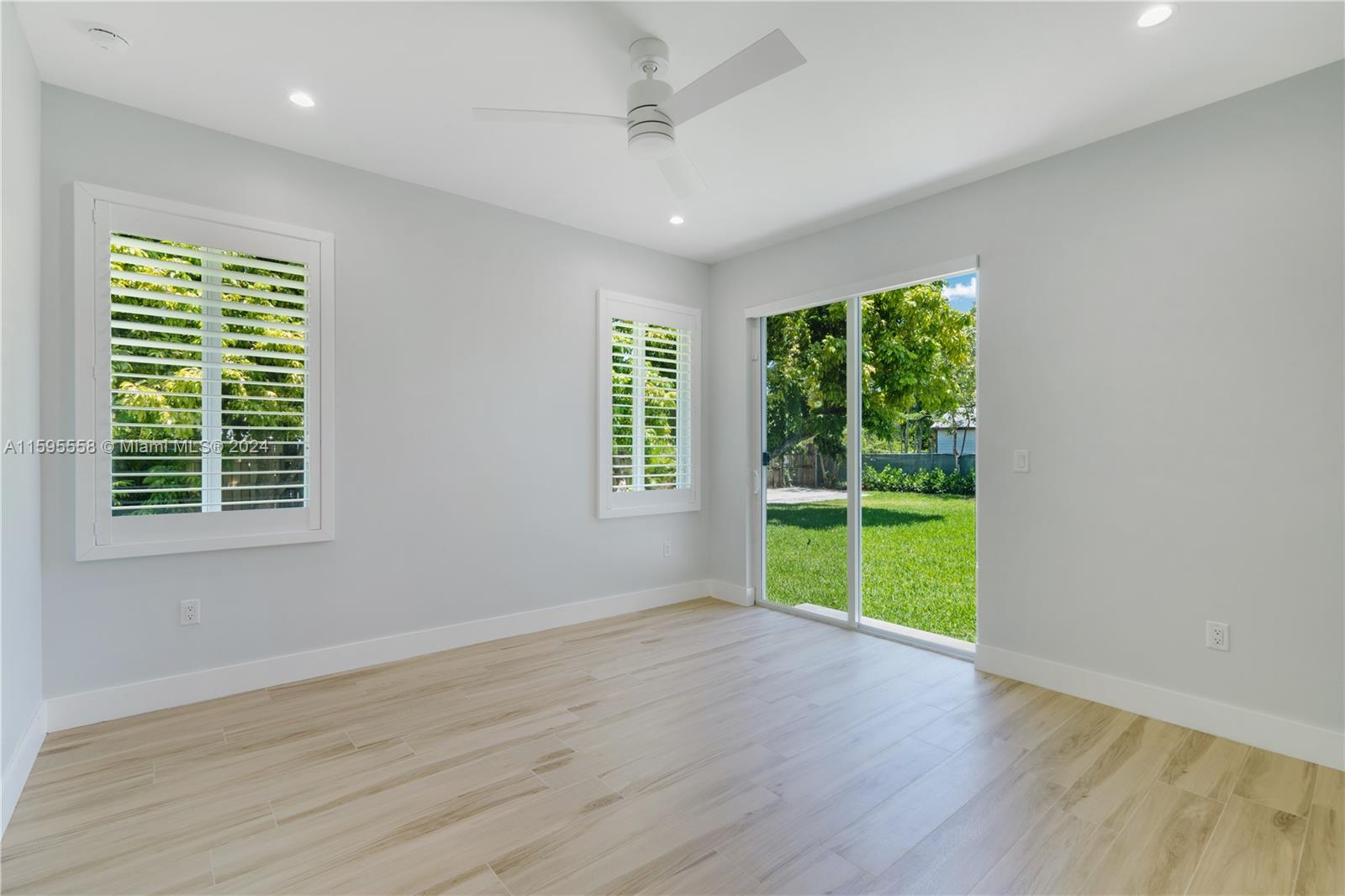 11815 Southwest 82nd Road Miami, FL 33156 - Photo 32 of 47 a view of an empty room with a window and wooden floor