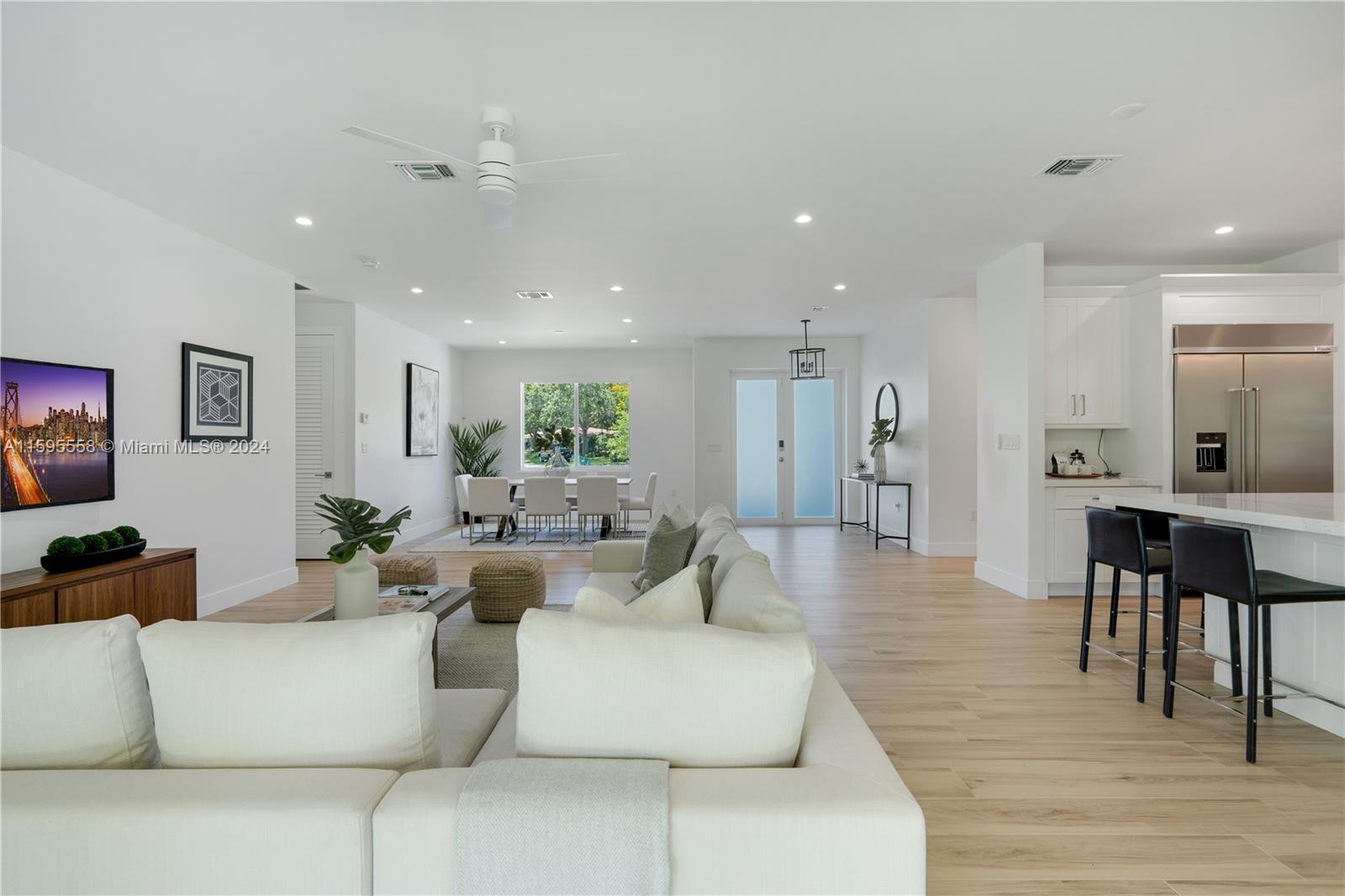 11815 Southwest 82nd Road Miami, FL 33156 - Photo 5 of 47 a living room with furniture and a dining table with wooden floor