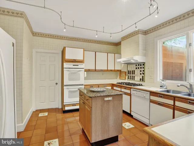 a kitchen with stainless steel appliances granite countertop a sink and cabinets