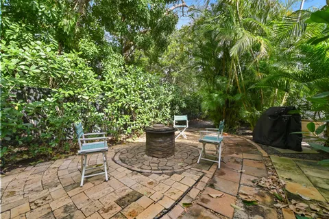 a view of a backyard with sitting area