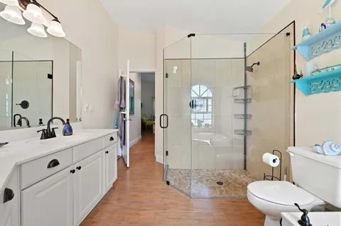 a bathroom with a sink a toilet and shower
