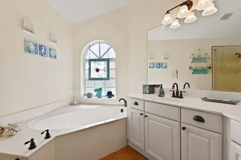 a bathroom with a sink a vanity and a mirror