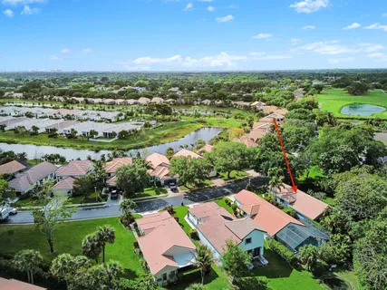 an aerial view of residential houses with outdoor space and trees