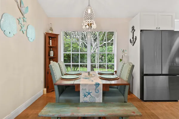 a outdoor dining room with furniture and a window