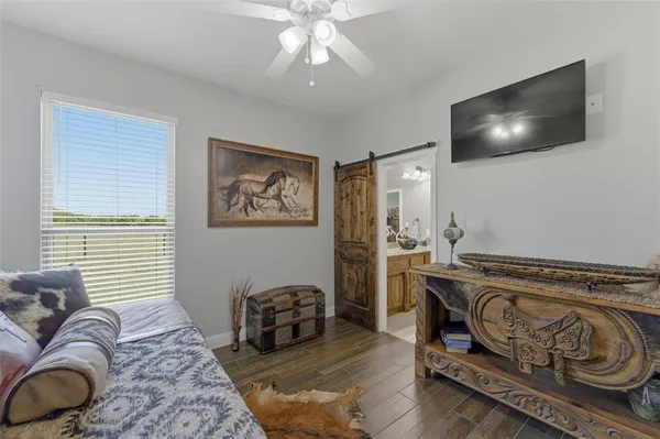 a bedroom with furniture and a flat screen tv