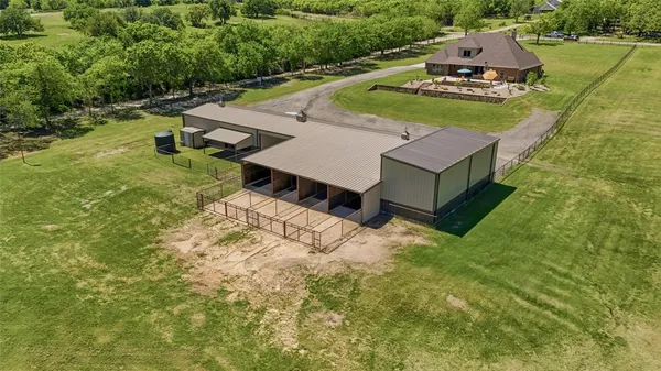 an aerial view of a house with a yard