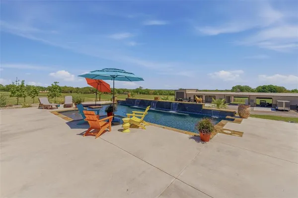 an outdoor space with pool and furniture