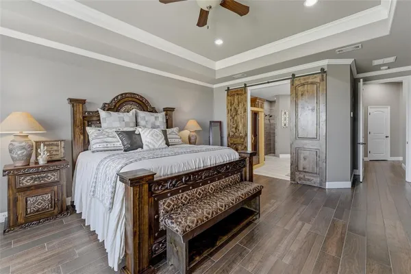 a spacious bedroom with a bed and a chandelier