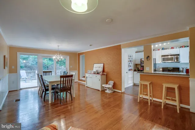 a dining room with furniture window and wooden floor