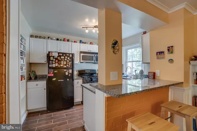 a kitchen with refrigerator and window