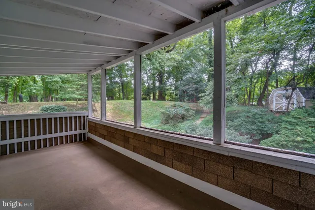 a view of a wooden deck with a yard