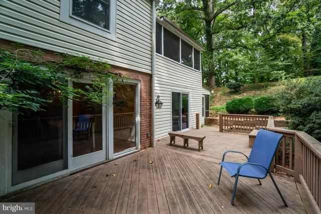 a view of a patio with table and chairs with wooden floor and fence