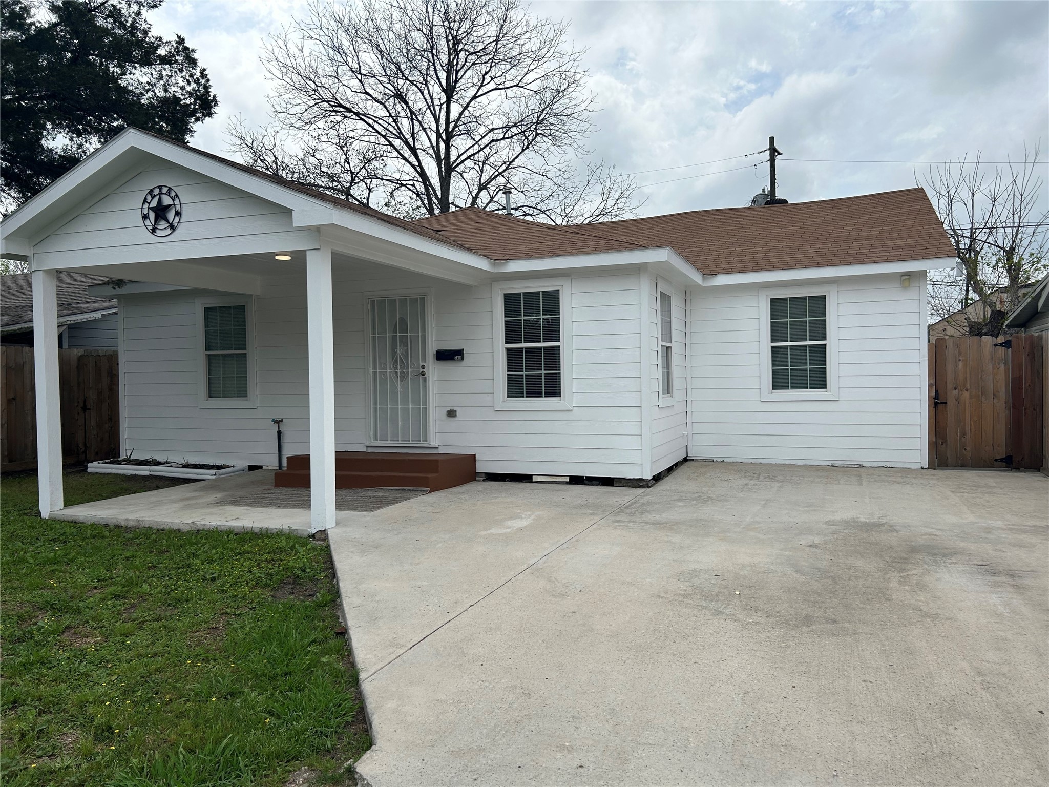 7410 Allsup Street Houston, TX 77061 - Photo 4 of 23 a front view of a house with a yard and garage