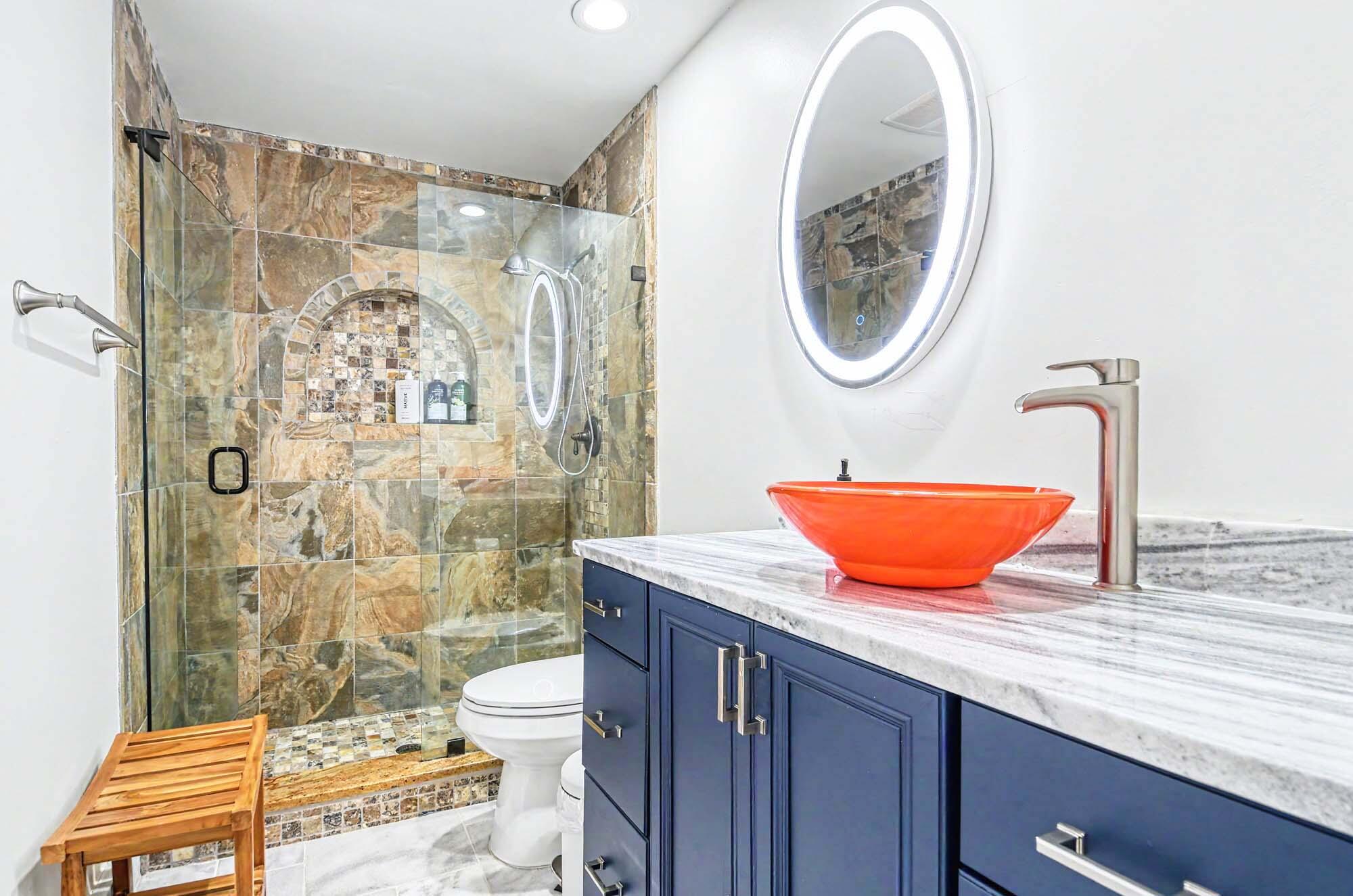 112 Capri Boulevard Naples, FL 34113 - Photo 17 of 29 a bathroom with a granite countertop sink mirror vanity and toilet