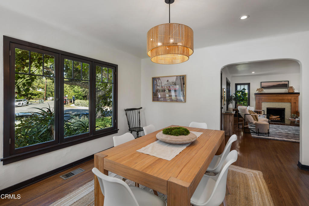 859 Sunset Avenue Pasadena, CA 91103 - Photo 16 of 76 a view of a dining room with furniture a chandelier and wooden floor