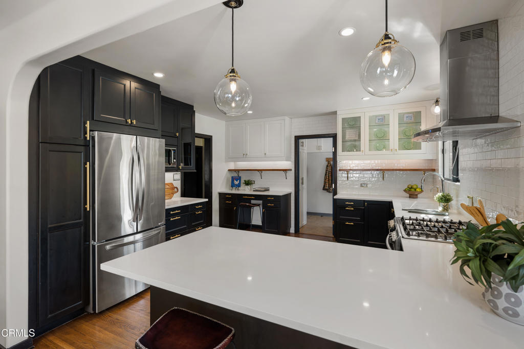 859 Sunset Avenue Pasadena, CA 91103 - Photo 20 of 76 a kitchen with stainless steel appliances a refrigerator sink and stove