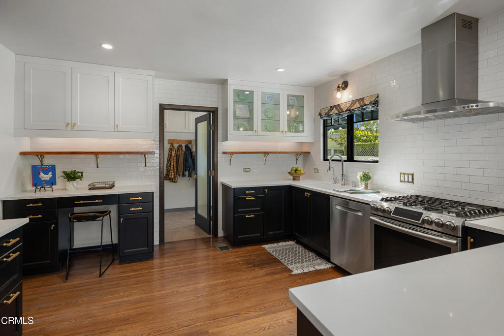 859 Sunset Avenue Pasadena, CA 91103 - Photo 21 of 76 a kitchen with stainless steel appliances granite countertop a sink stove and refrigerator