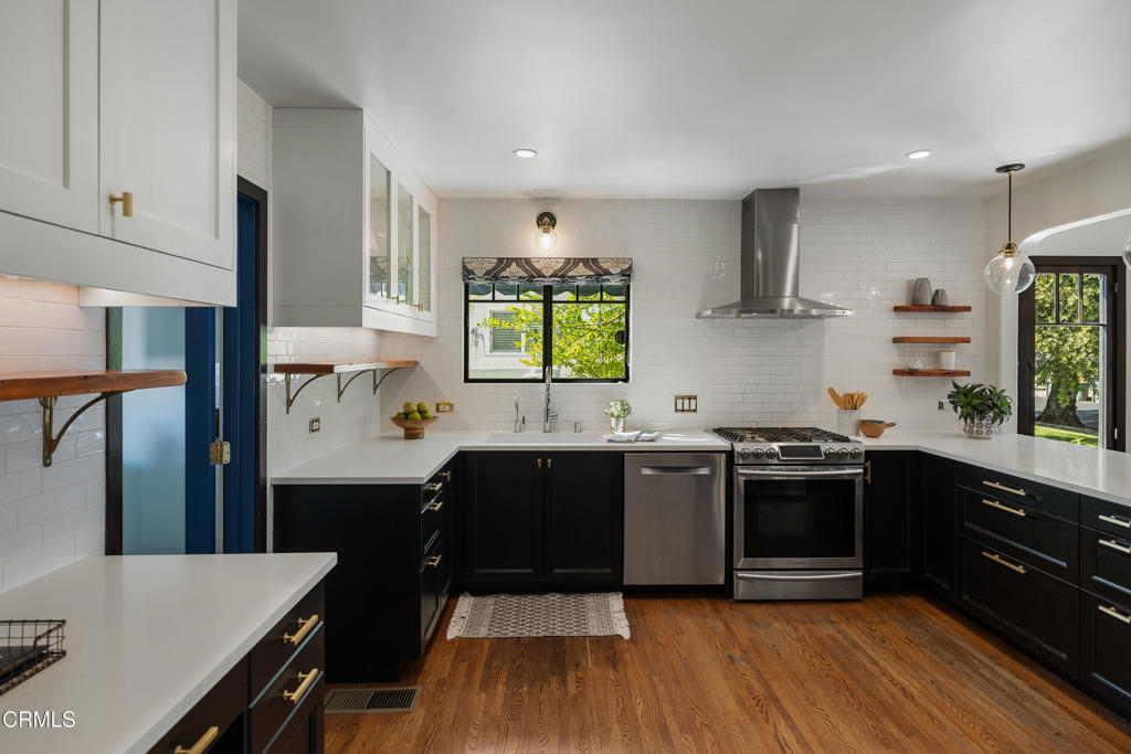 859 Sunset Avenue Pasadena, CA 91103 - Photo 23 of 76 a kitchen with stainless steel appliances granite countertop a sink a stove and a refrigerator