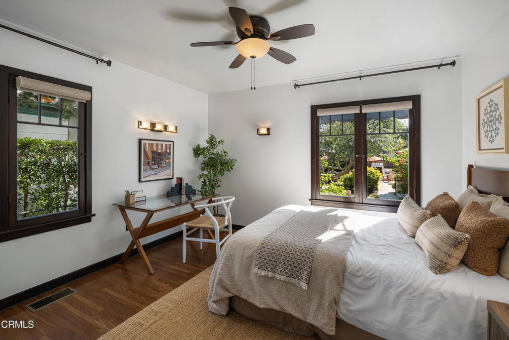 859 Sunset Avenue Pasadena, CA 91103 - Photo 29 of 76 a bedroom with a bed and a chandelier