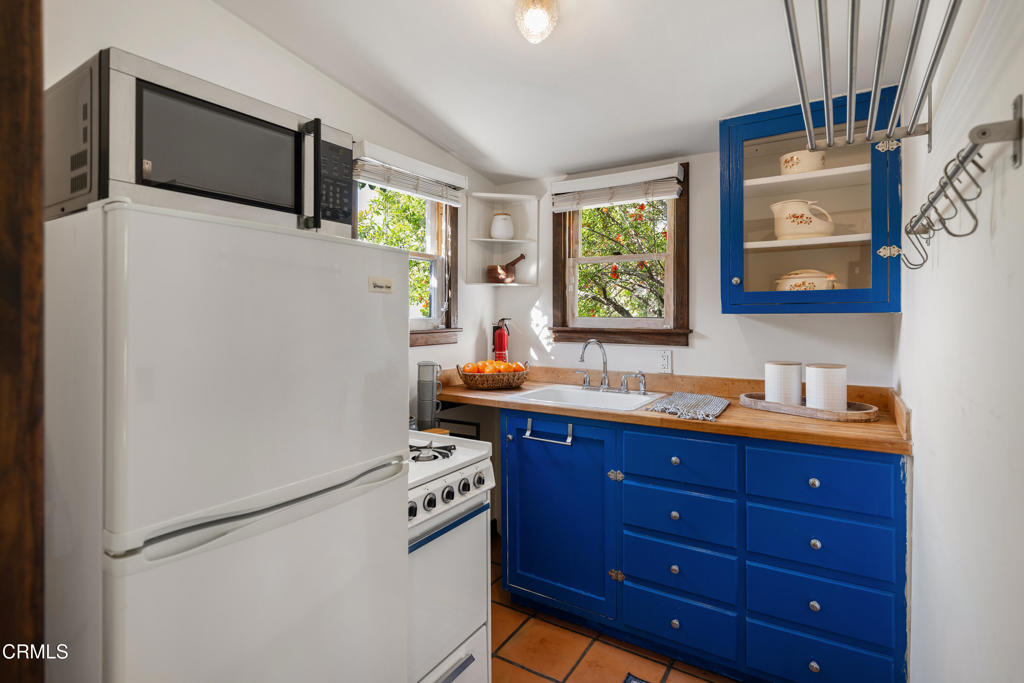 859 Sunset Avenue Pasadena, CA 91103 - Photo 45 of 76 a kitchen with stainless steel appliances granite countertop a refrigerator sink and microwave
