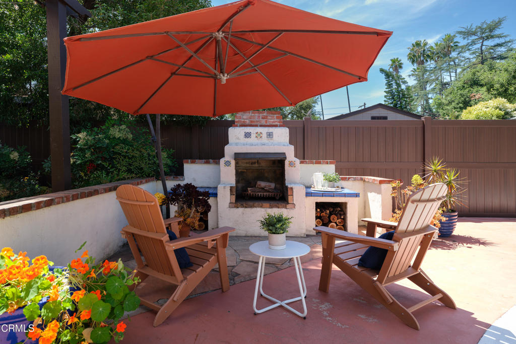 859 Sunset Avenue Pasadena, CA 91103 - Photo 54 of 76 a view of a chairs and table under an umbrella in the patio