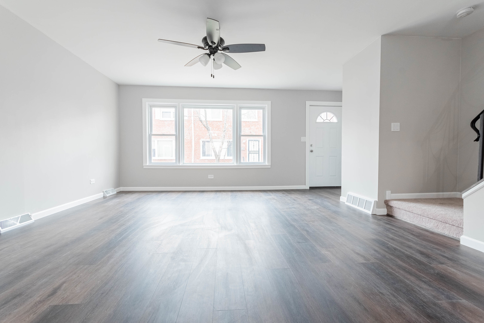 9515 Sumac Road, Unit F Des Plaines, IL 60016 - Photo 11 of 25 a view of an empty room with wooden floor and a window