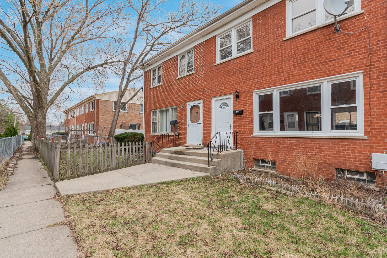 9515 Sumac Road, Unit F Des Plaines, IL 60016 - Photo 25 of 25 a view of a brick building next to a yard