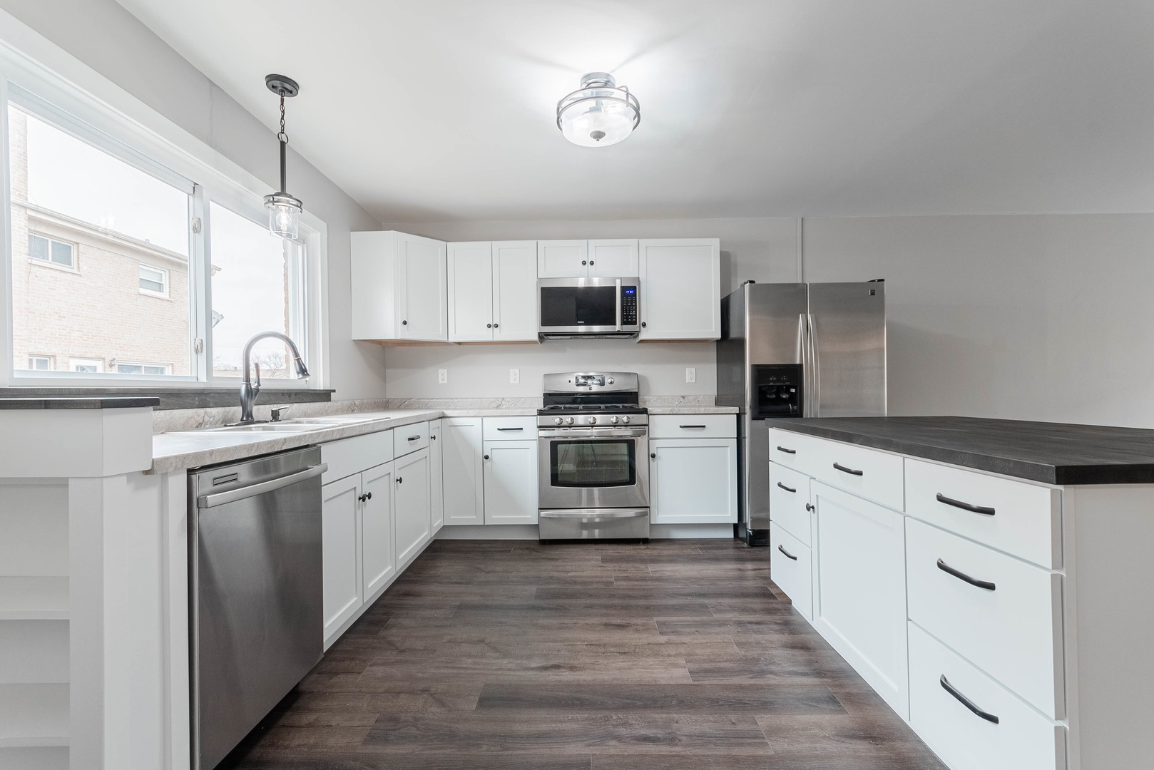 9515 Sumac Road, Unit F Des Plaines, IL 60016 - Photo 6 of 25 a kitchen with granite countertop white cabinets and stainless steel appliances